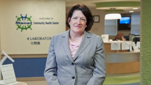 Portrait of Cynthia Sierra (CEO of Manet Community Health Center) standing in the CHC lobby