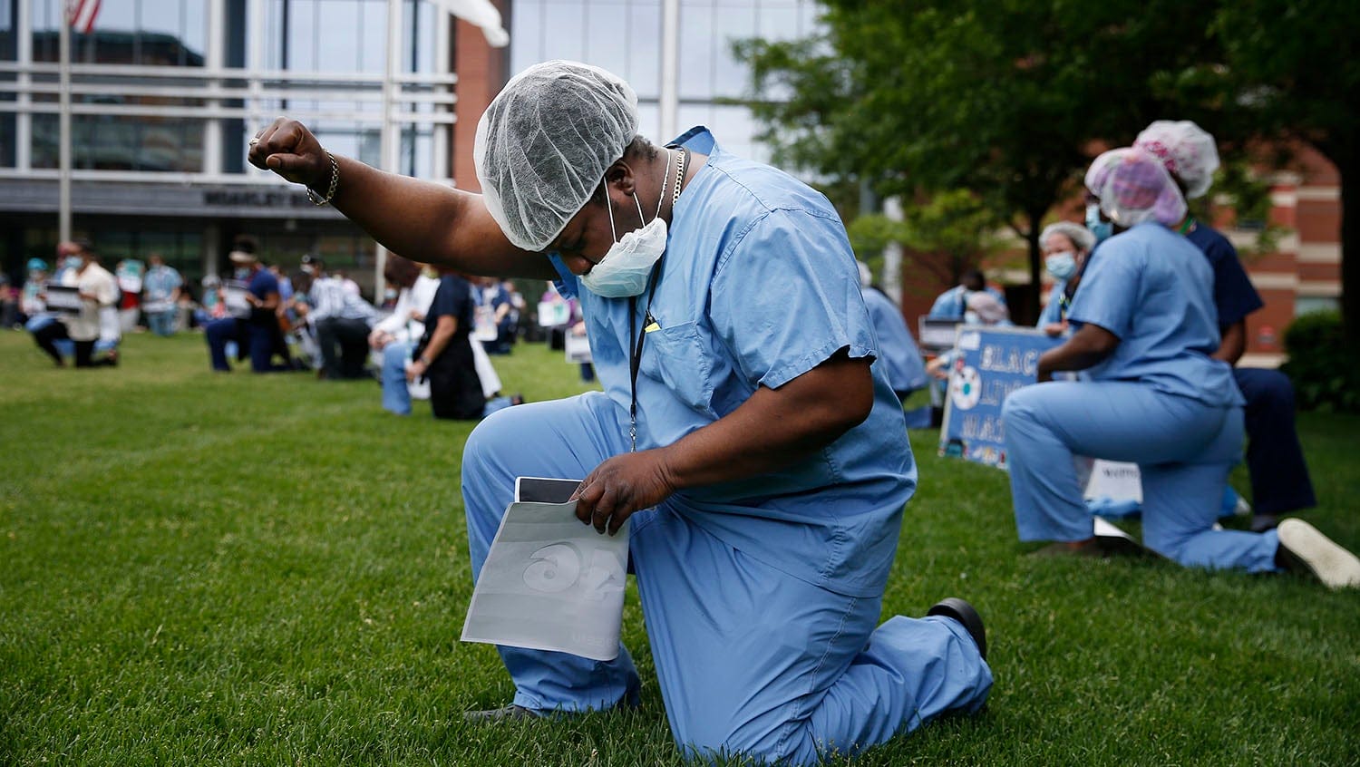 doctor kneels in black lives matter protest at boston medical center
