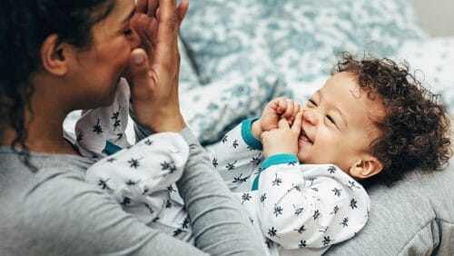 New mother with her baby playing parenting intervention BRIGHT for moms with opioid addiction