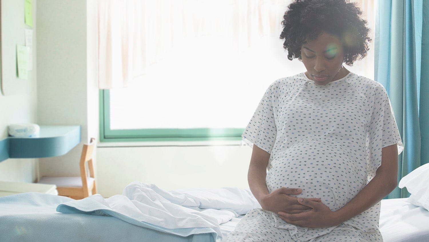 black woman pregnant doula in hospital