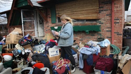 pregnant woman housing eviction with boxes outside her home