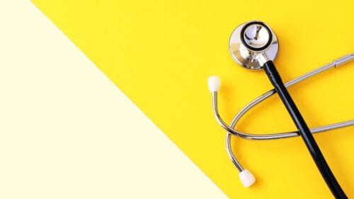 stethoscope set on a yellow background