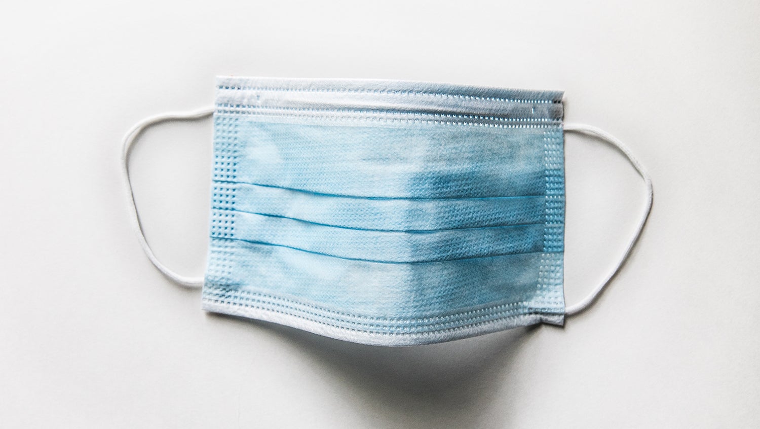 Blue surgical mask on a white background