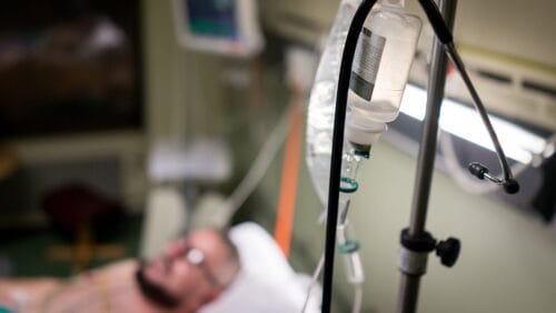 man laying in a hospital bed