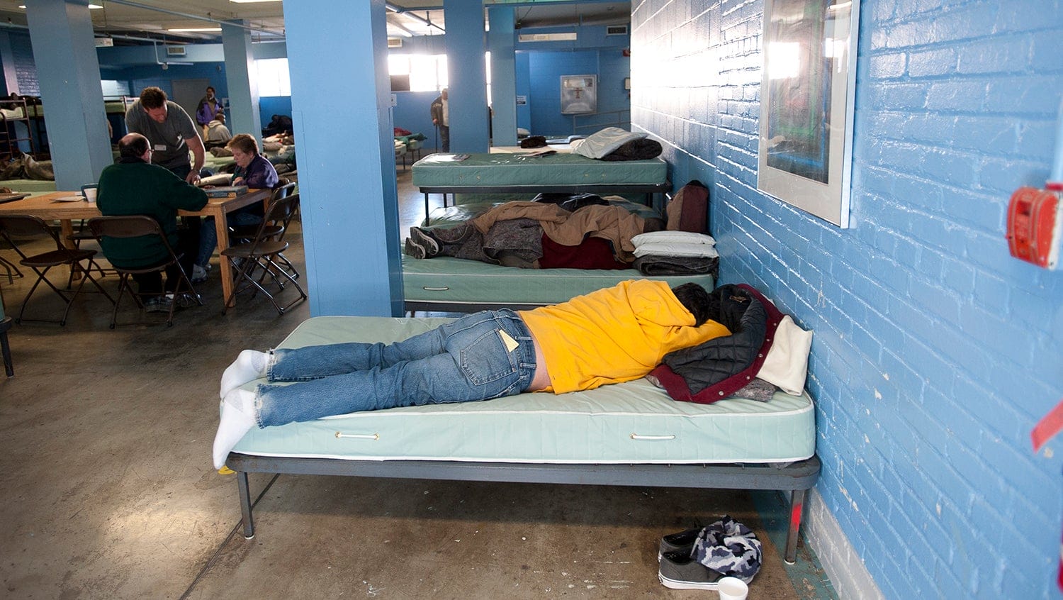 Guests at Pine Street Inn lay on cots 