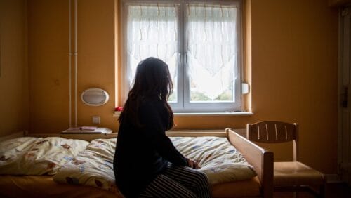 woman sitting on a bed with a sleep disorder