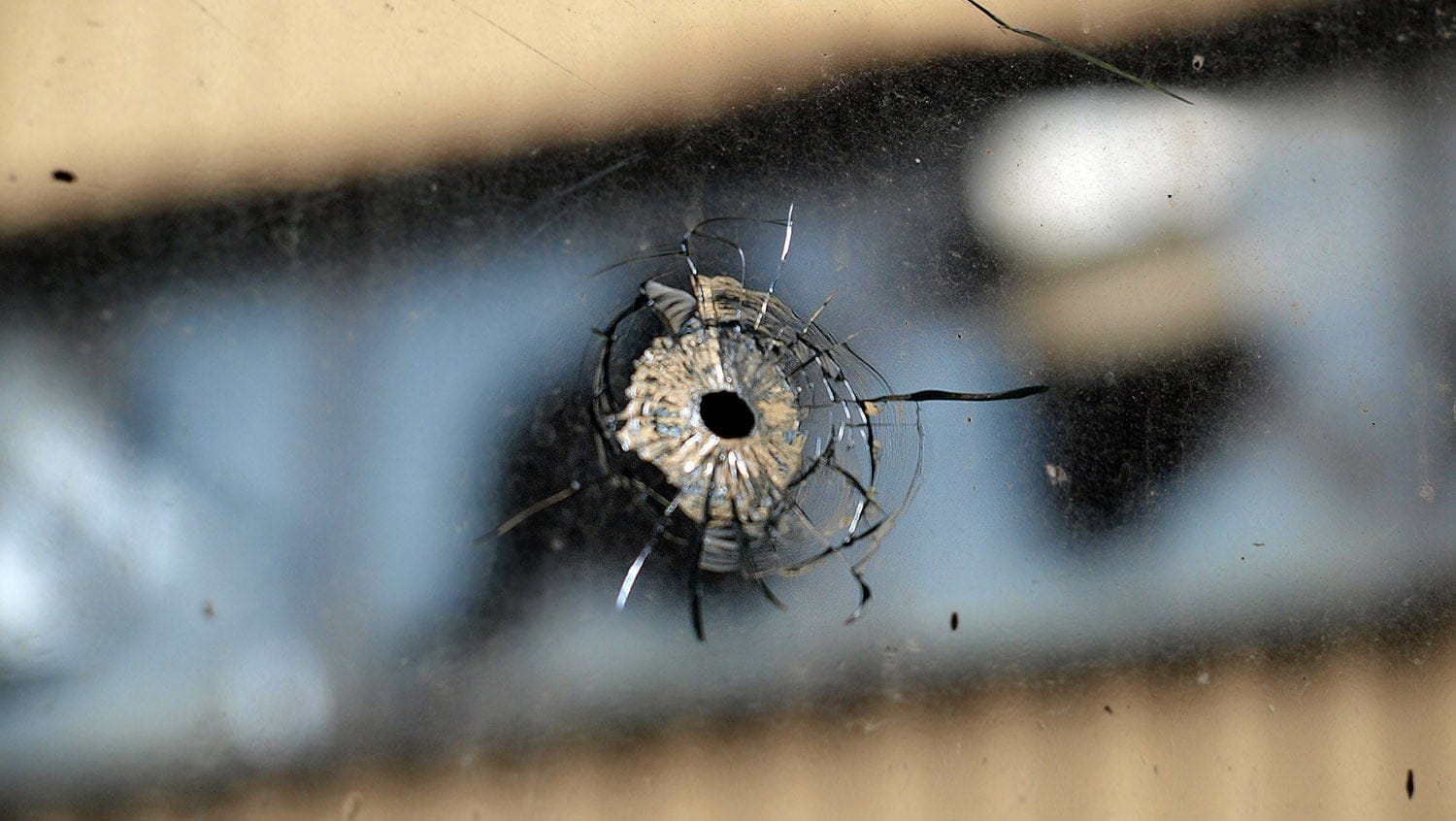 A gunshot hole in glass window
