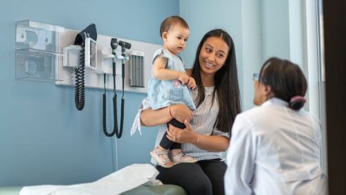 pediatrician with mom and baby patient talking about vaccine concerns