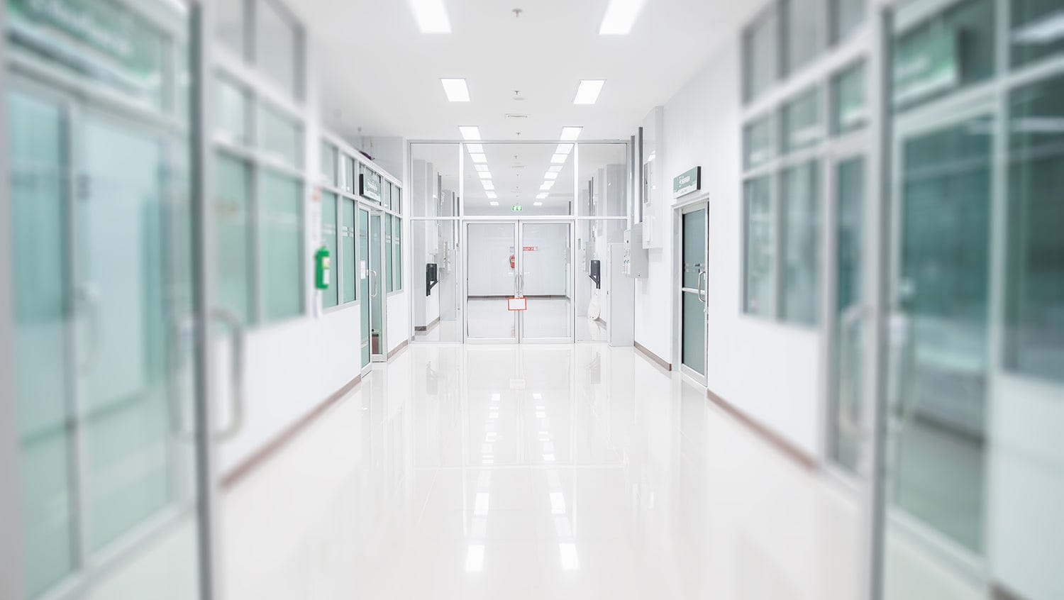 Empty and clean white hospital hallway