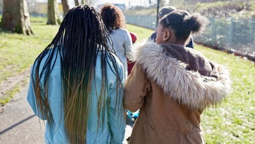 back view of group of teens walking outside