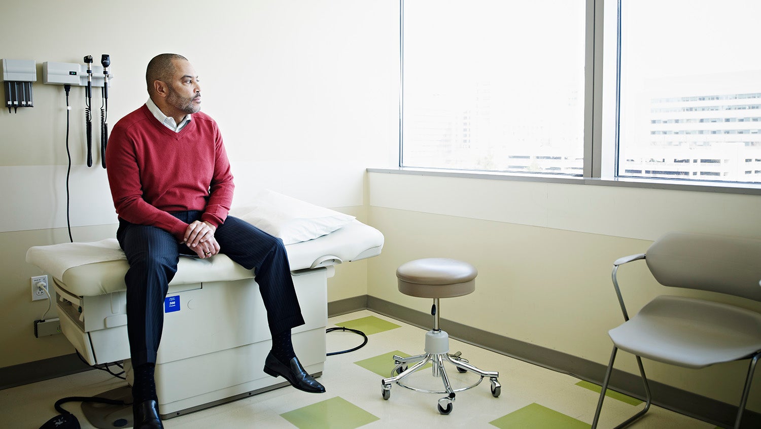 healthcare reparations for black man sitting on a hospital bed 