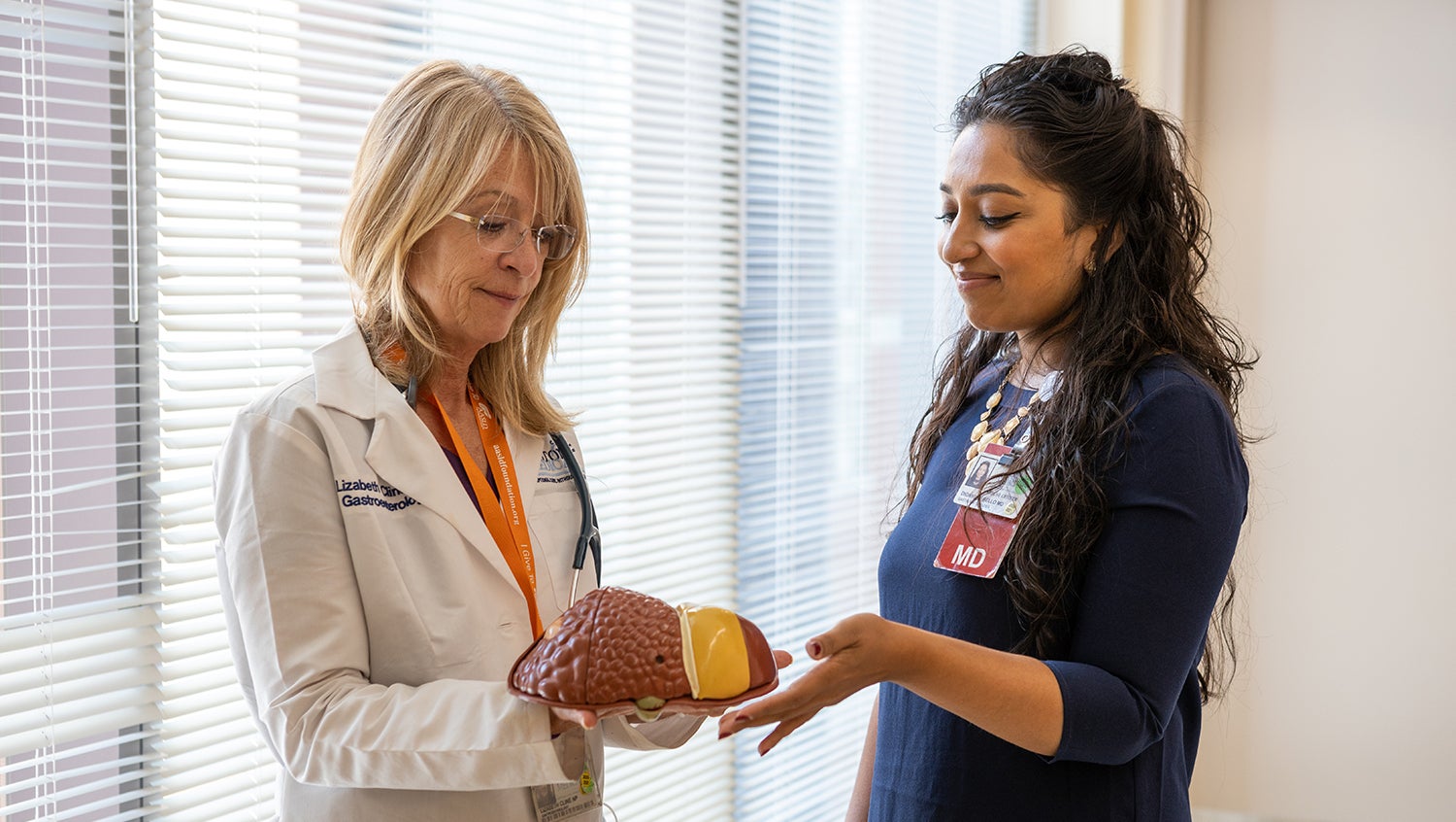 Two female gastroenterologists talk to each other