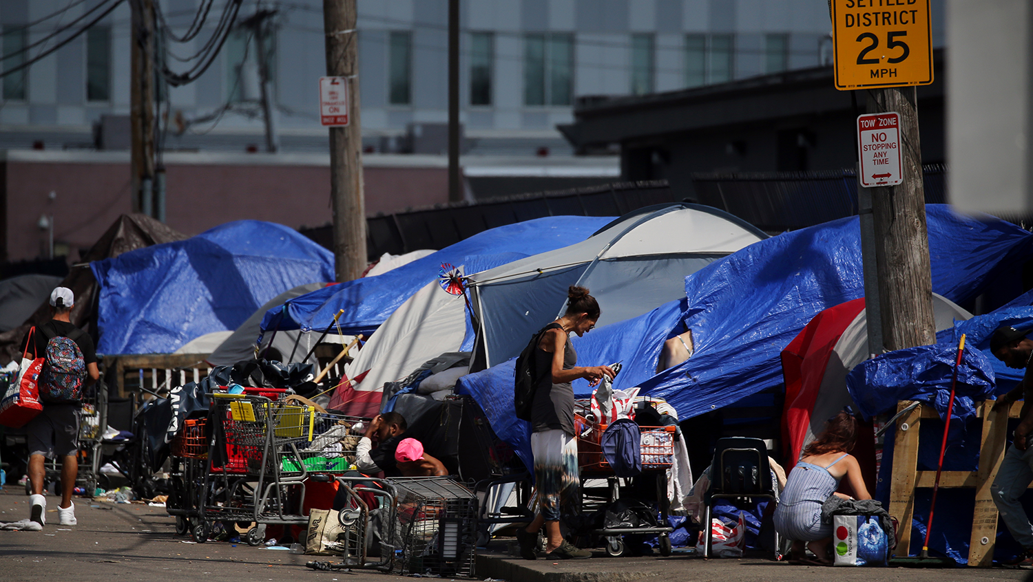 Tents and makeshift shelters line Topeka Street in the area known as Mass and Cass in Boston