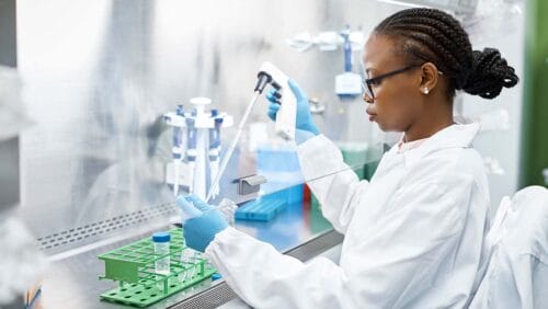 Female scientist analyzing HIV medical sample in test tube