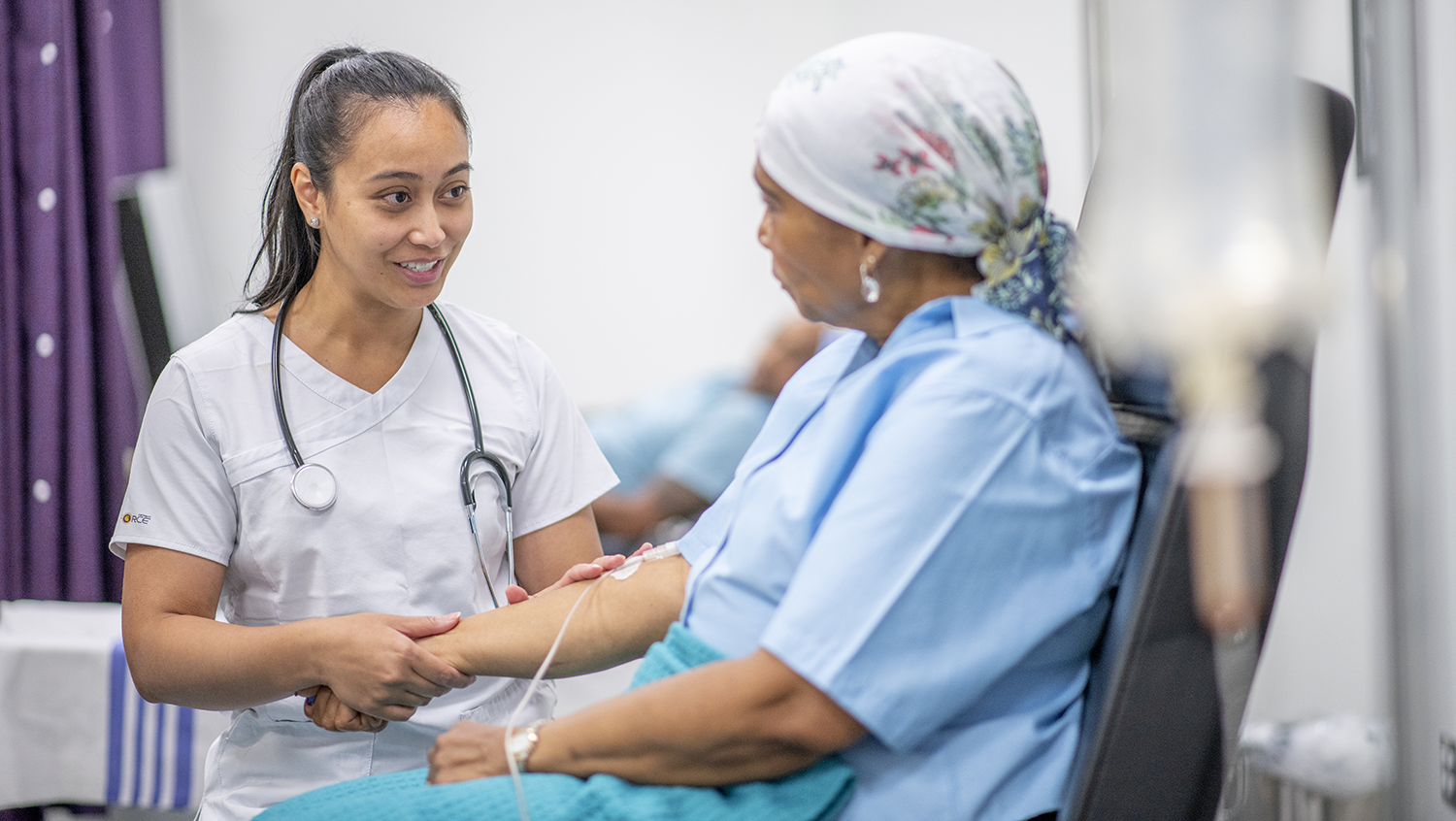 Physician speaking with cancer patient