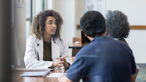 Doctor speaking with two patients