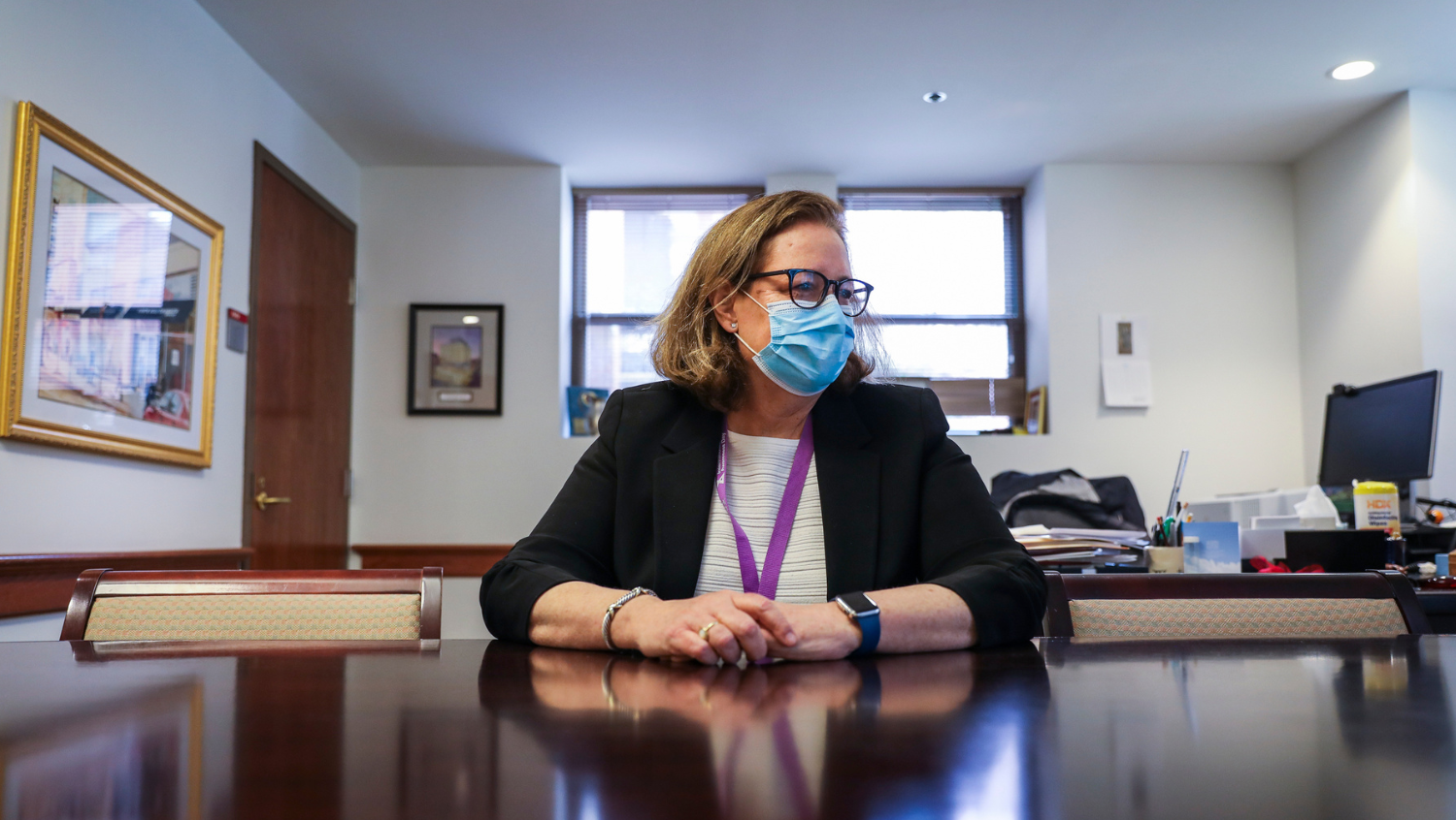 Photo of Kate Walsh, CEO of Boston Medical Center Health System, behind her desk