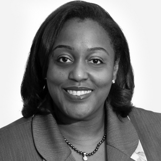 Dr. Lovern Moseley headshot. She is a Black woman smiling and staring straight at the camera. The photo is in Black and White