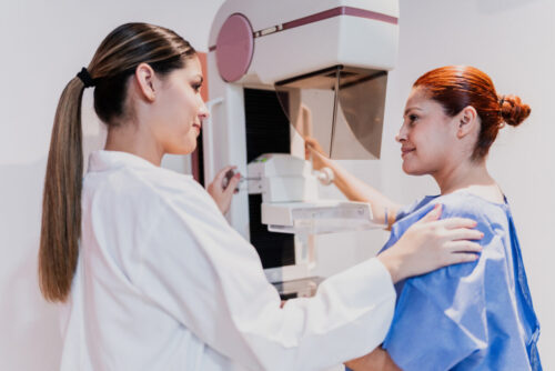 Doctor doing mammogram exam on patient at hospital