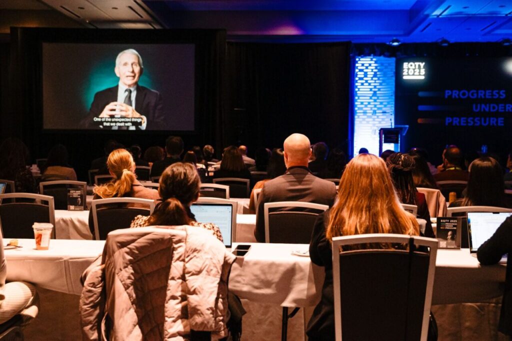 Crowd listens in to pre recorded remarks from Anthony Fauci, Physician and former Chief Medical Advisor to the President of United States. Piper Brown Photography. 