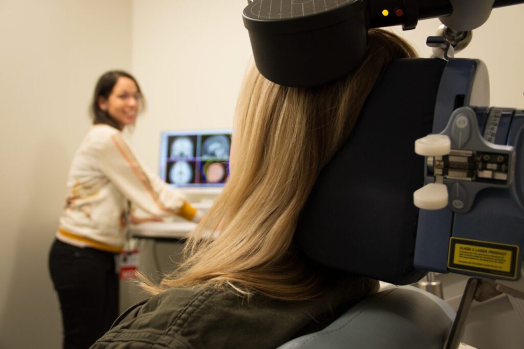 Doctor Rivas-Grajales and patient discuss brain scan.