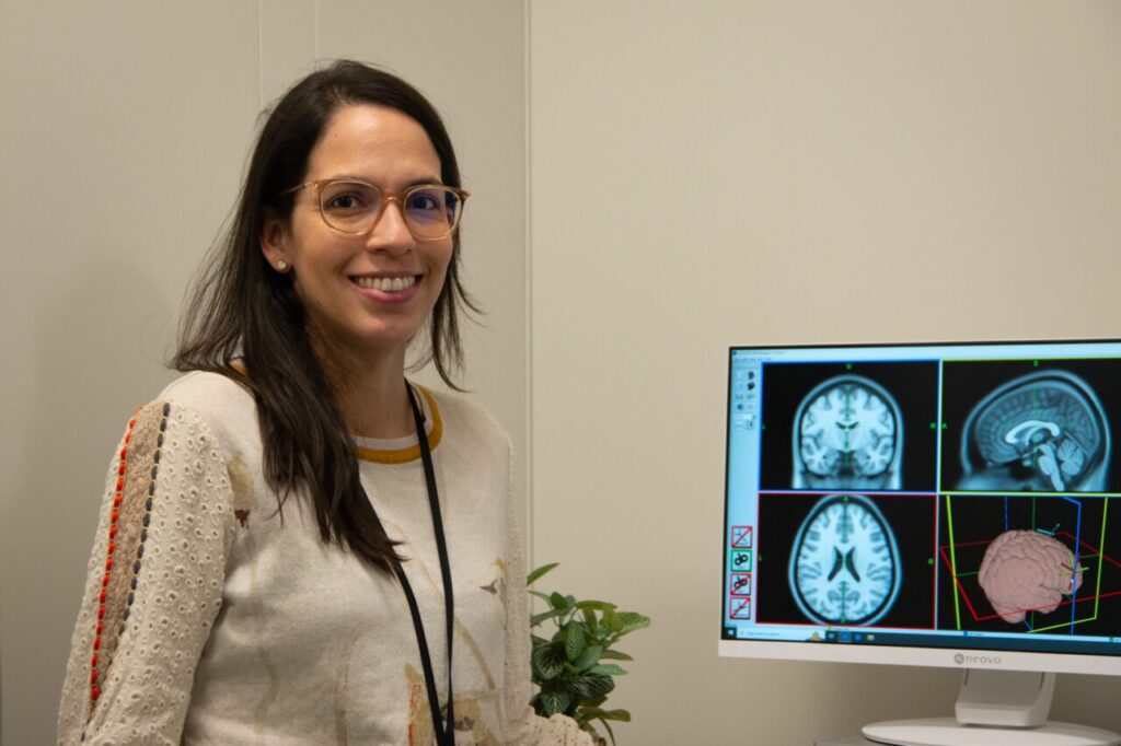 Doctor Rivas-Grajales poses by computer.