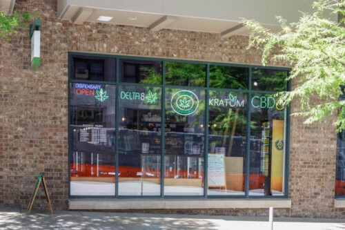 Asheville, NC, USA-4 May 2023: A CBD, medical cannabis dispensary.  Glass window front showing filled shelves.
