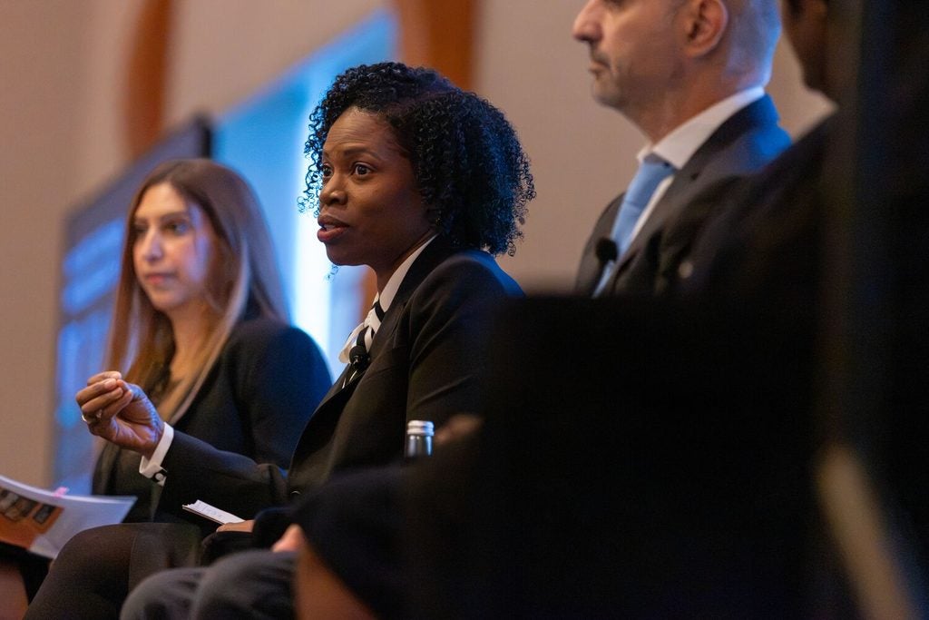 Angela Moore from Novartis sitting on a panel and speaking at the Inclusive Research Symposium at EQTY 2026.