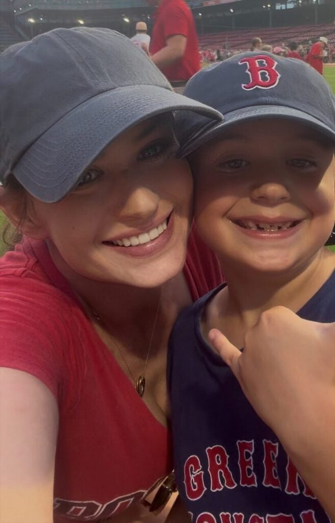 woman and son in red sox hats close up in a selfie
